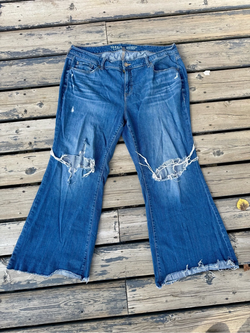 torrid distressed blue super flare jeans with raw hem